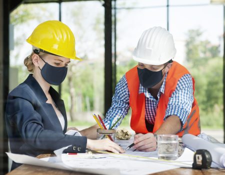 architects in face mask planning construction in new normal
